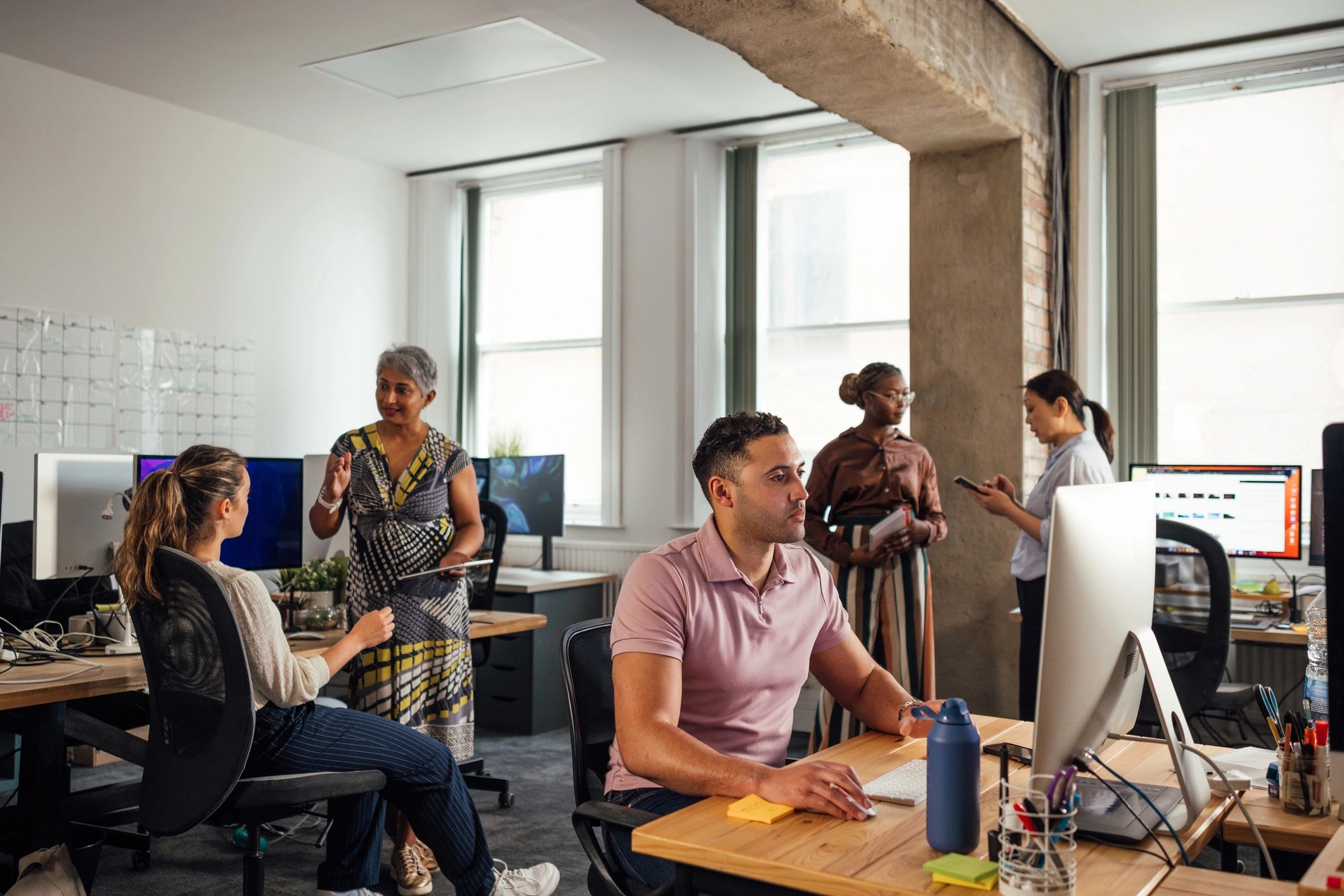 Editorial team collaborating in a modern workspace