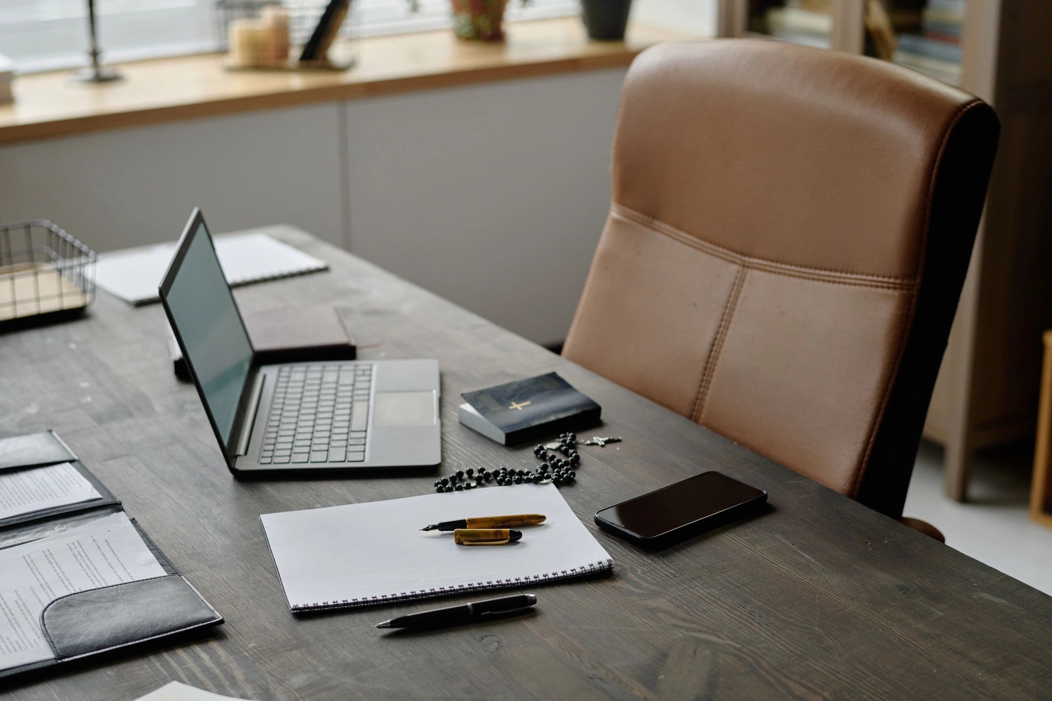 Desk with notebook and digital devices representing online publishing and data handling